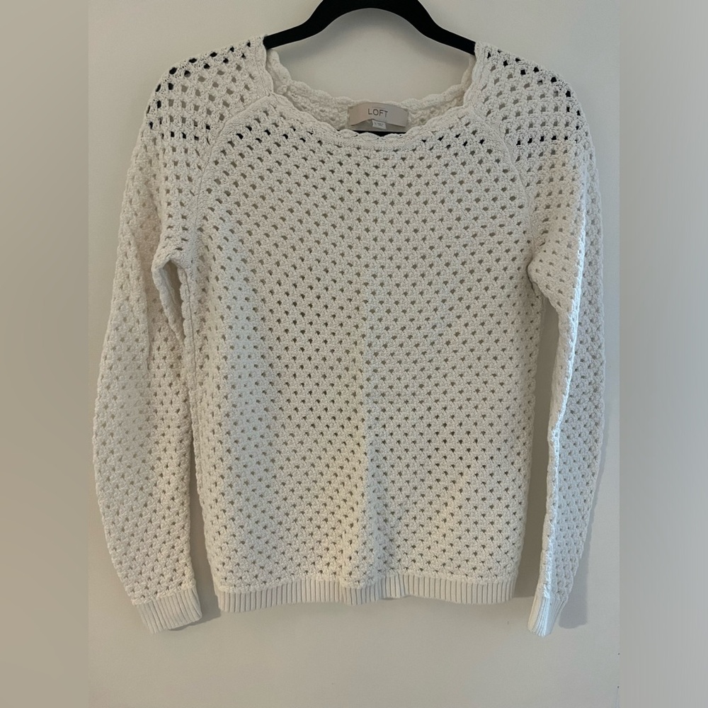 Knit white sweater with scalloped collar and see-through pattern.